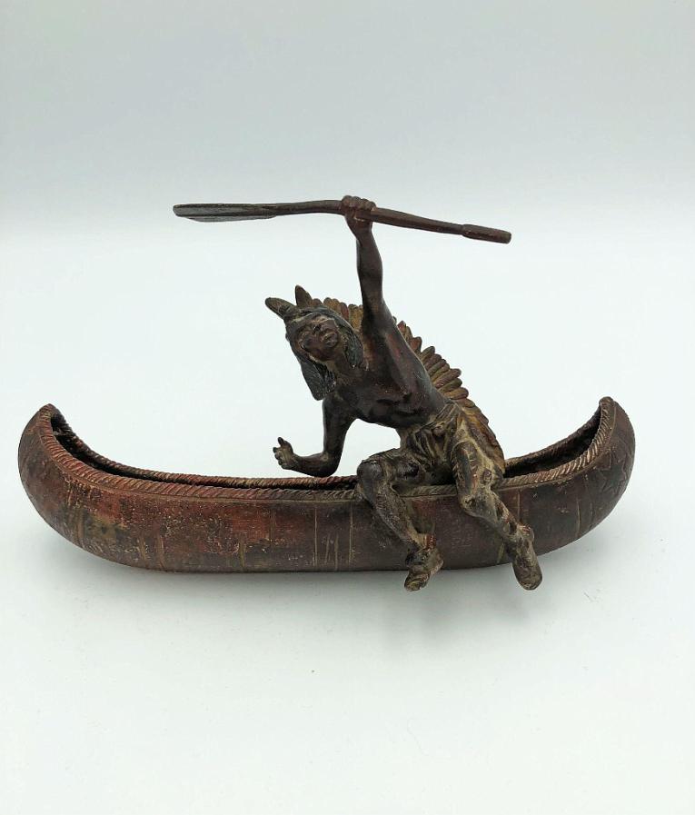 Indian Exiting Canoe with Oar in Hand